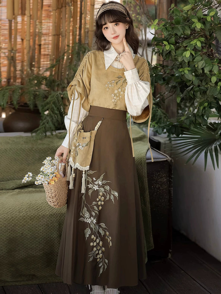 Woman in traditional outfit with embroidered skirt and floral top, holding a basket, in a warm-toned indoor setting.