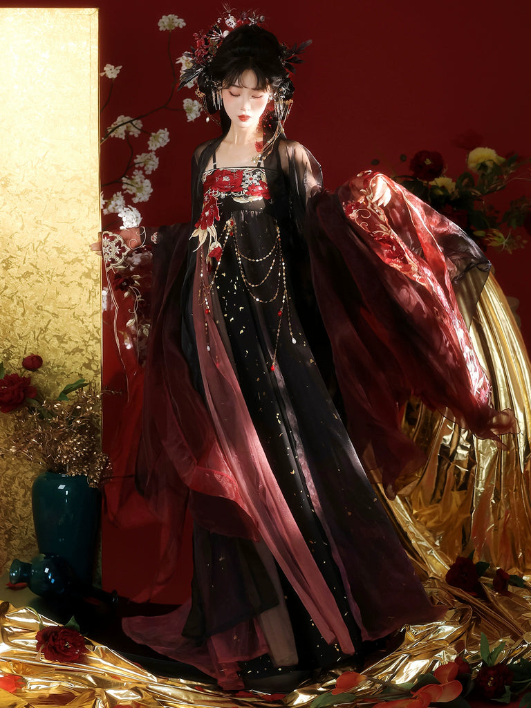 Person in traditional dark and red costume with floral headpiece against a decorative background