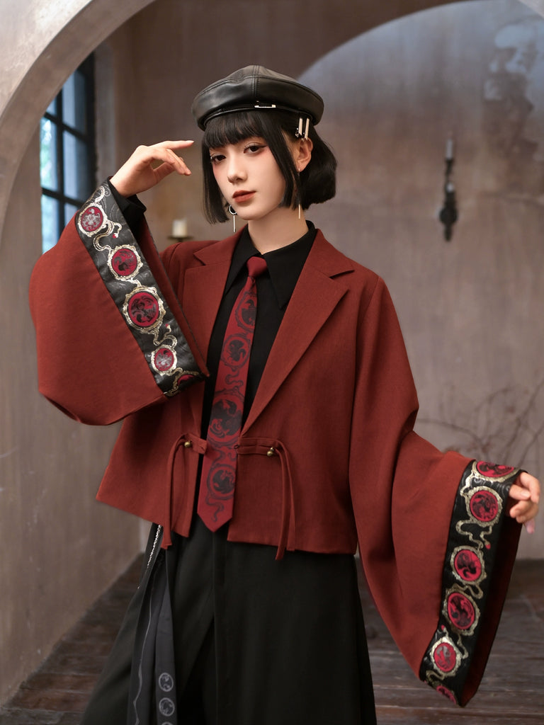 Person wearing a red coat with floral patterns and a black hat in an indoor setting.
